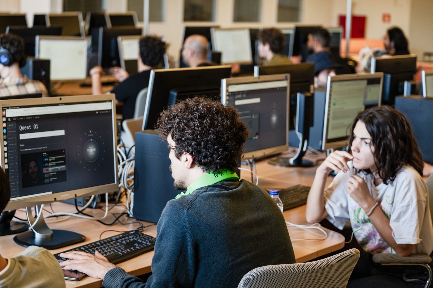 Two people working together at a screen during an A³ workshop