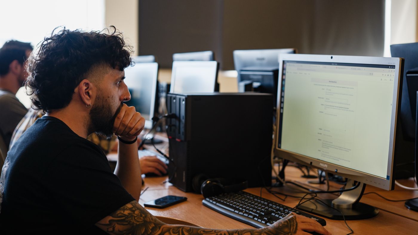 A practitioner working through a task at a screen on the A³ campus