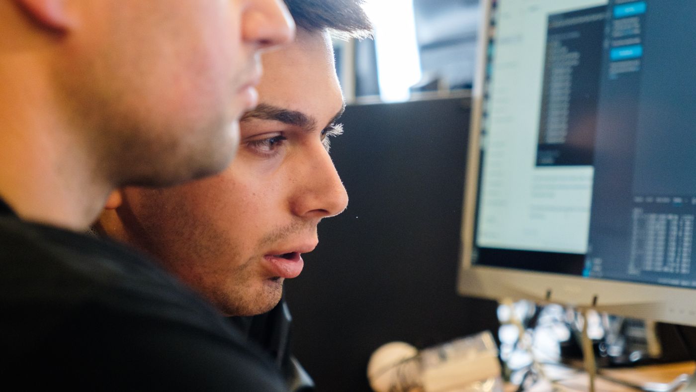 A practitioner working at a screen during a session on the A³ campus